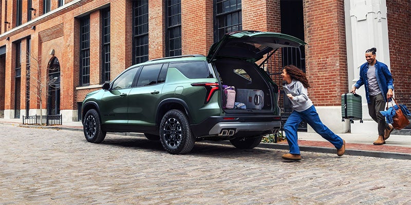 A Chevrolet Traverse with its trunk open, showcasing spacious cargo area and interior design.
